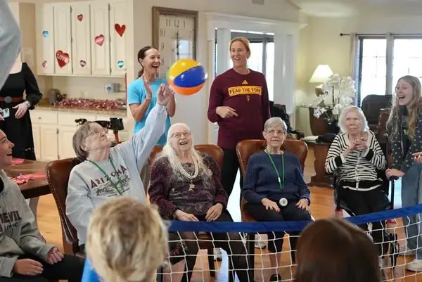 Residents playing indoor volleyball with ASU athletes at Sweetwater Groves Scottsdale